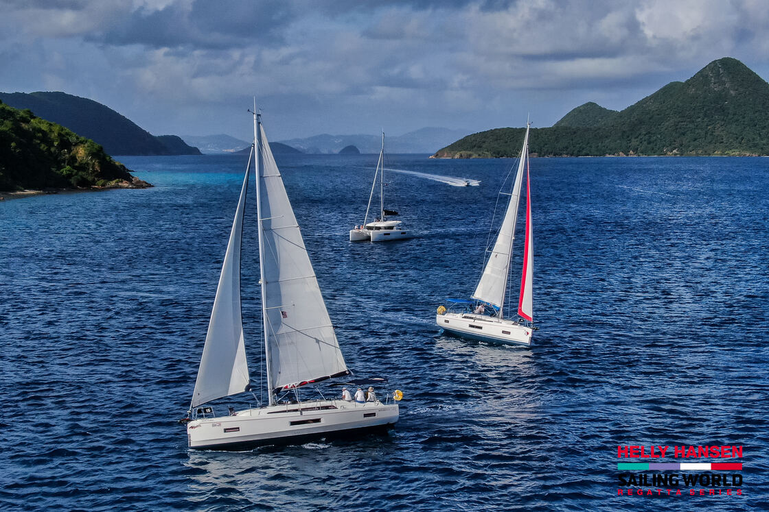 Race fleet sailing between the islands on Day 5