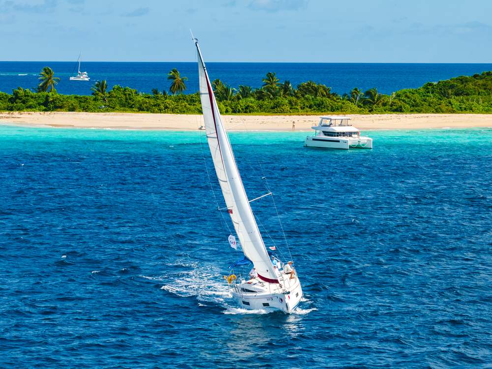 Sailboat approaching a BVI beach