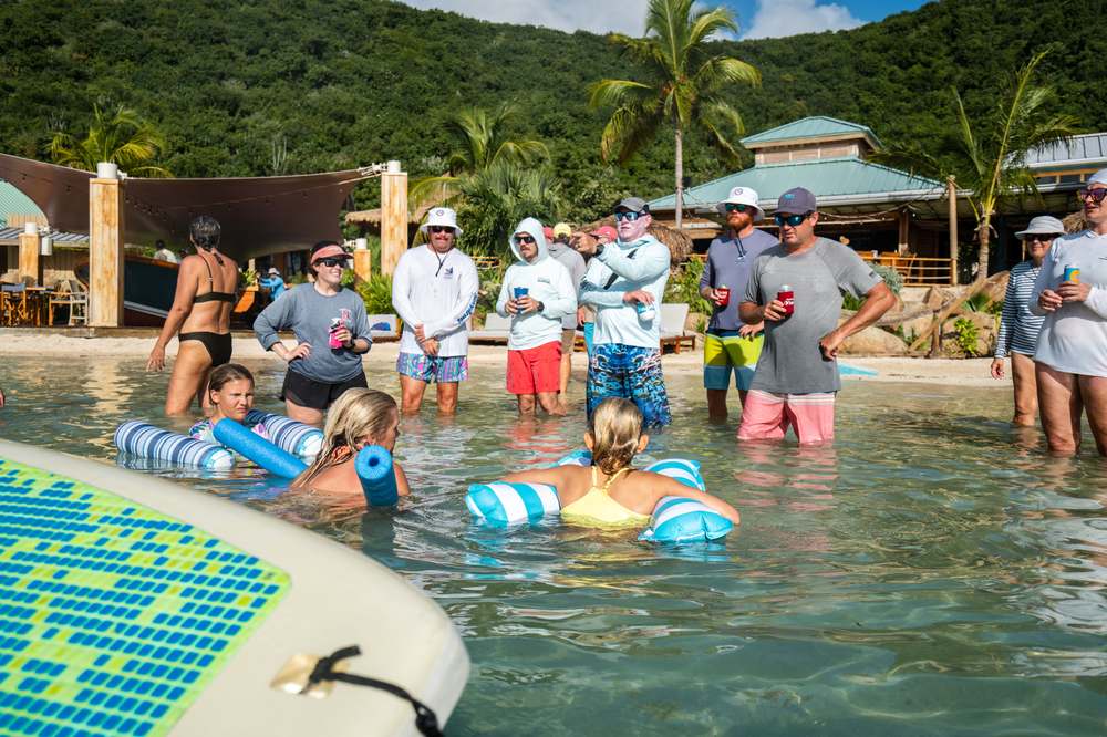 Guests relaxing in the water at a beach party